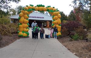  Kids and staff standing under pumpkin arch